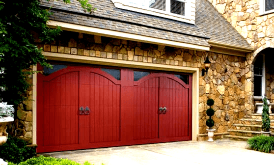Red carriage-style double garage door on a stone-front Spokane home