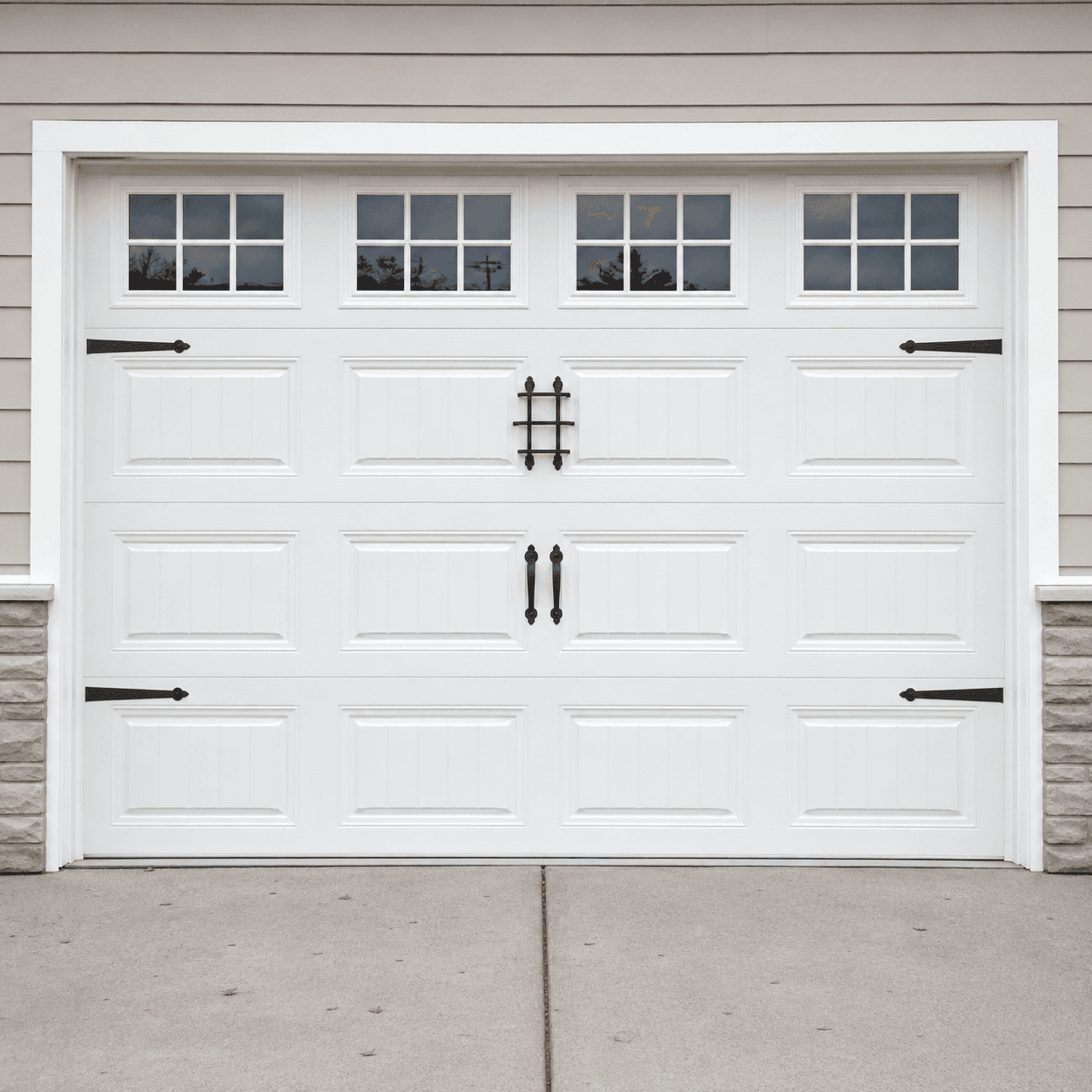 White raised-panel insulated door with decorative hardware
