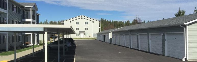 Full building of matching garage doors installed by GDS at a large residential community