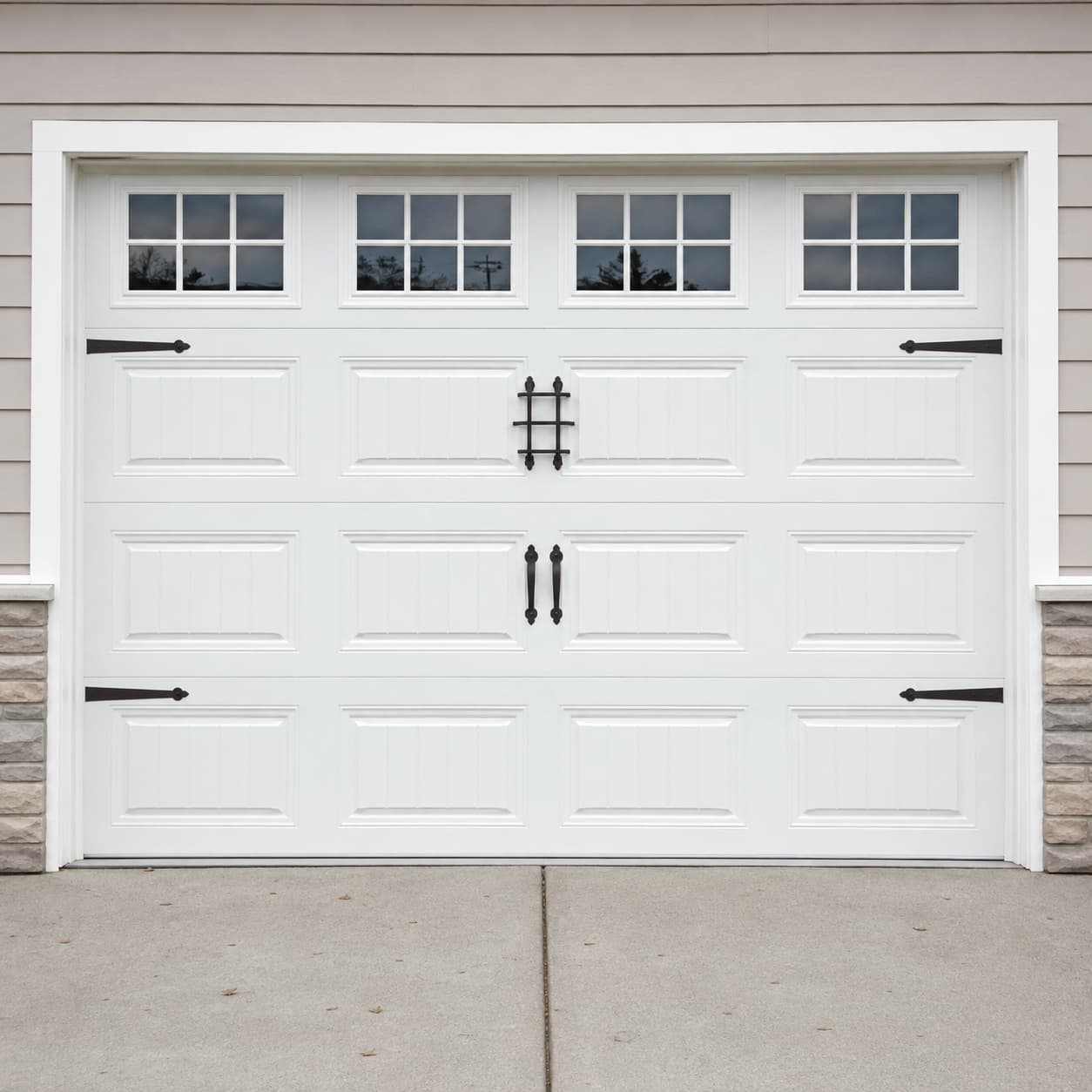 White raised-panel insulated door with decorative hardware